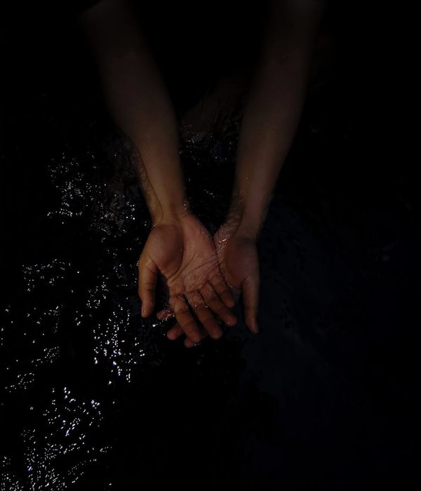 Person in a spacious, minimalist room with natural light, performing a fluid motion.